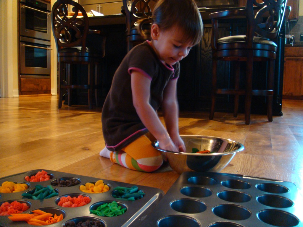 Liliana playing with colored pasta